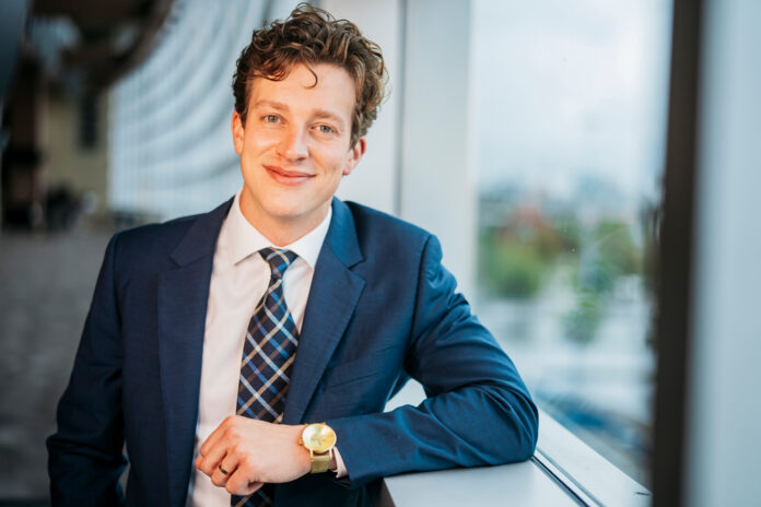 Tate Kelly, USL Senior Vice President of Partnerships, in a professional business setting.