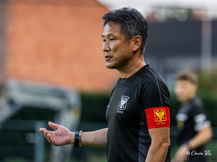 suyoshi Takano gestures while coaching in Sint Truiden VV training kit.